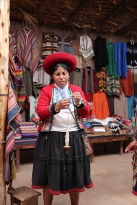 A demonstration on how to make the alpaca hair into yarn by twirling it on a spindle